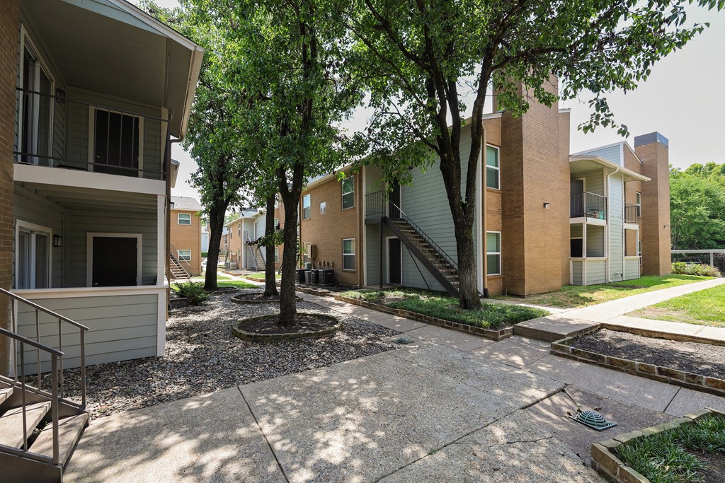 View of shaded sidewalk through property and private patio/balcony