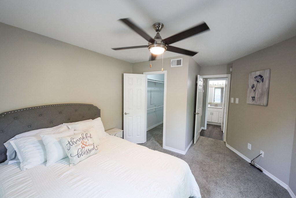View from bedroom into closet and across the hall from bathroom