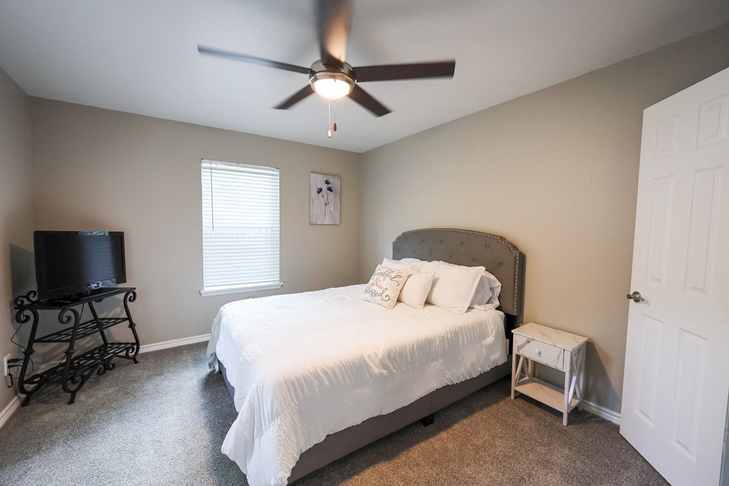 View of bedroom with carpet floors and well lit window