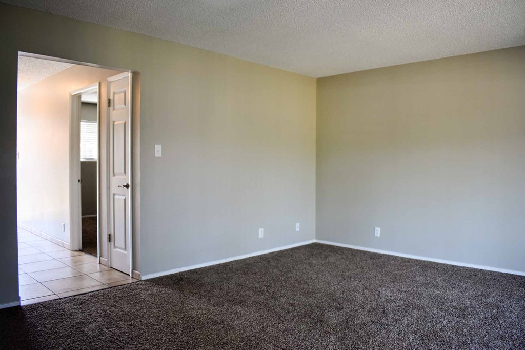 Carpeted bedroom view into tiled hallway