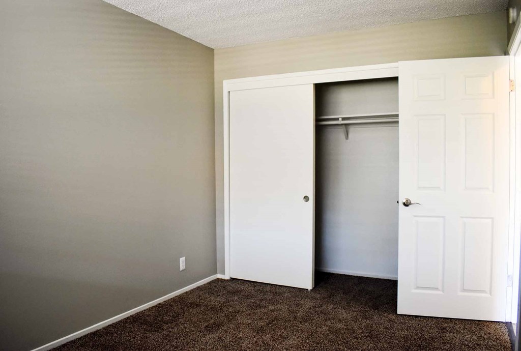 bedroom with carpet flooring and sliding door closet
