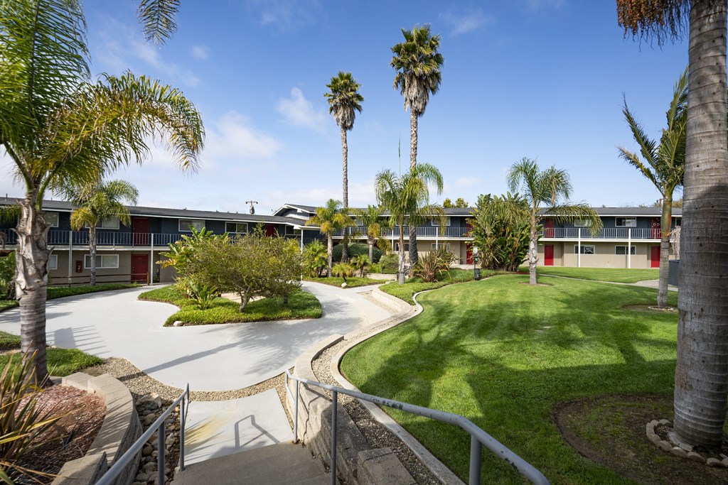 a building with palm trees in the background