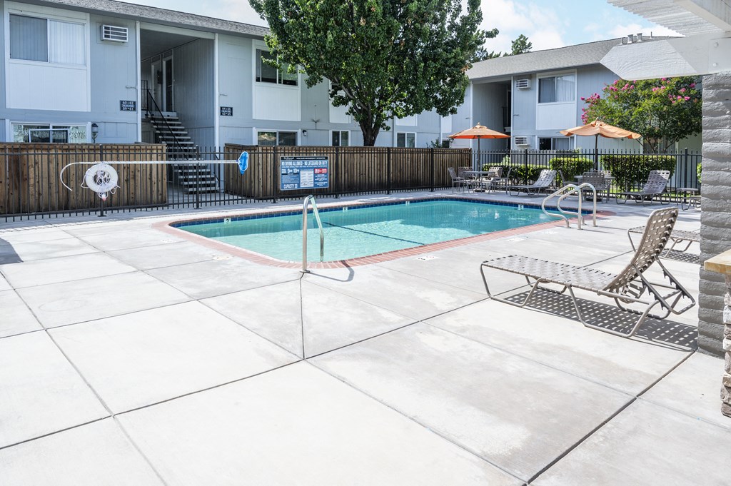 our apartments have a swimming pool and a patio with chairs
