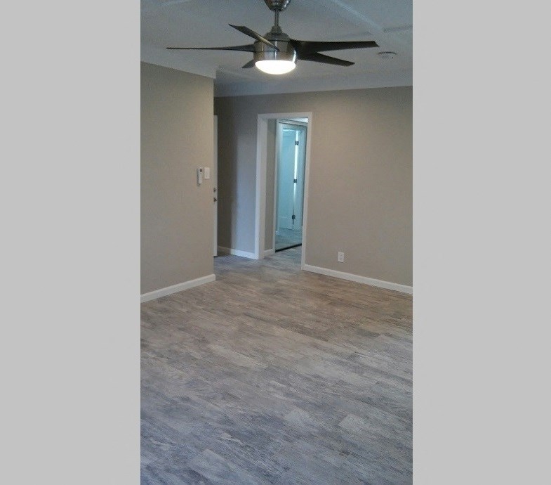 Living area with wood look flooring and ceiling fan