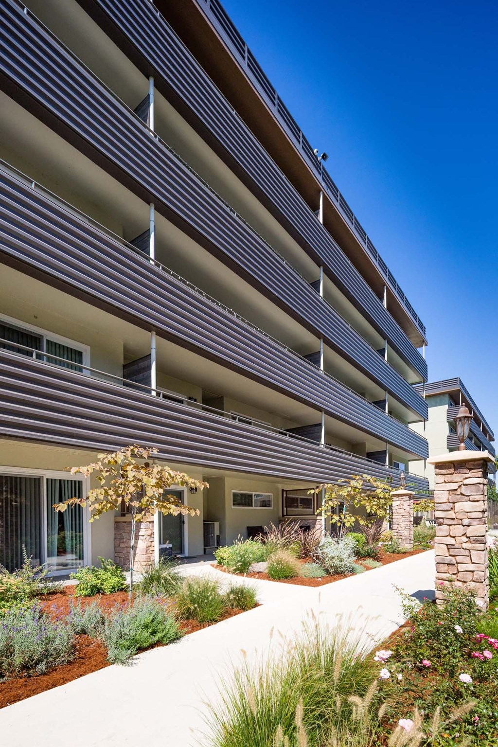 an apartment building with a walkway in front of it