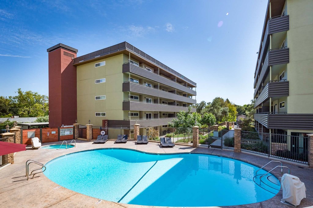 a swimming pool with a building in the background