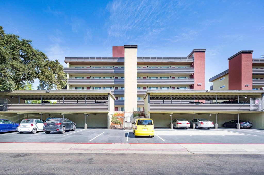 a parking lot with cars in front of a building