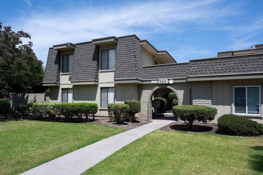 a house with a sidewalk in front of it
