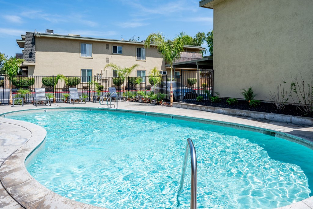 a swimming pool with a building in the background