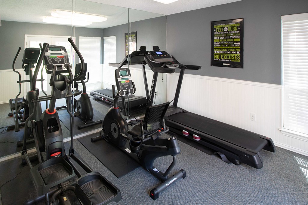 View of cardio center with treadmill, stationary bike, and elliptical