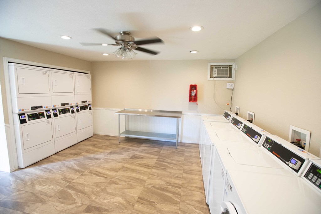 Clothes care facility with multiple washer and dryers and folding station