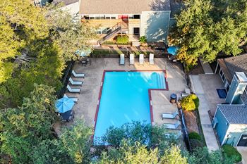 a view of the pool from above of the backyard of a house with a pool
