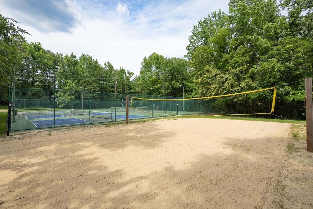 View of sand volleyball court with tennis, basketball, and pickleball ball court in background