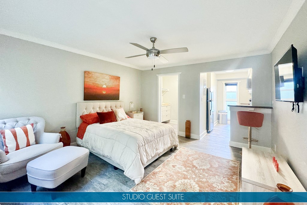 a bedroom with a bed and a ceiling fan