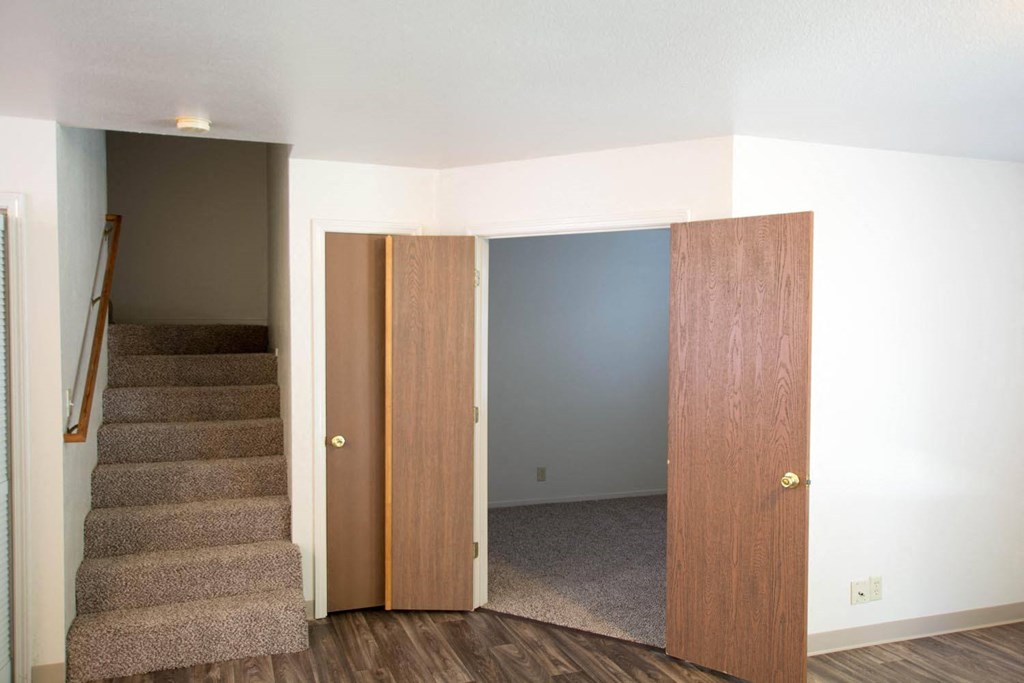 View of stairs leading to upstairs bedroom and view into downstairs bedroom