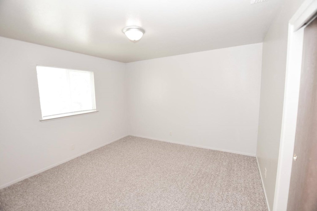 View of upstairs carpeted bedroom with well lit window