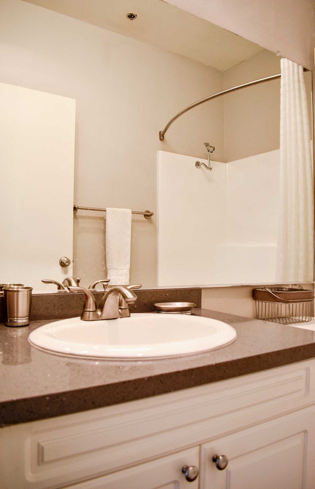 View of bathroom vanity with sink, mirror, and rub shower combo