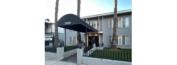 A building with a black awning that says 7510.