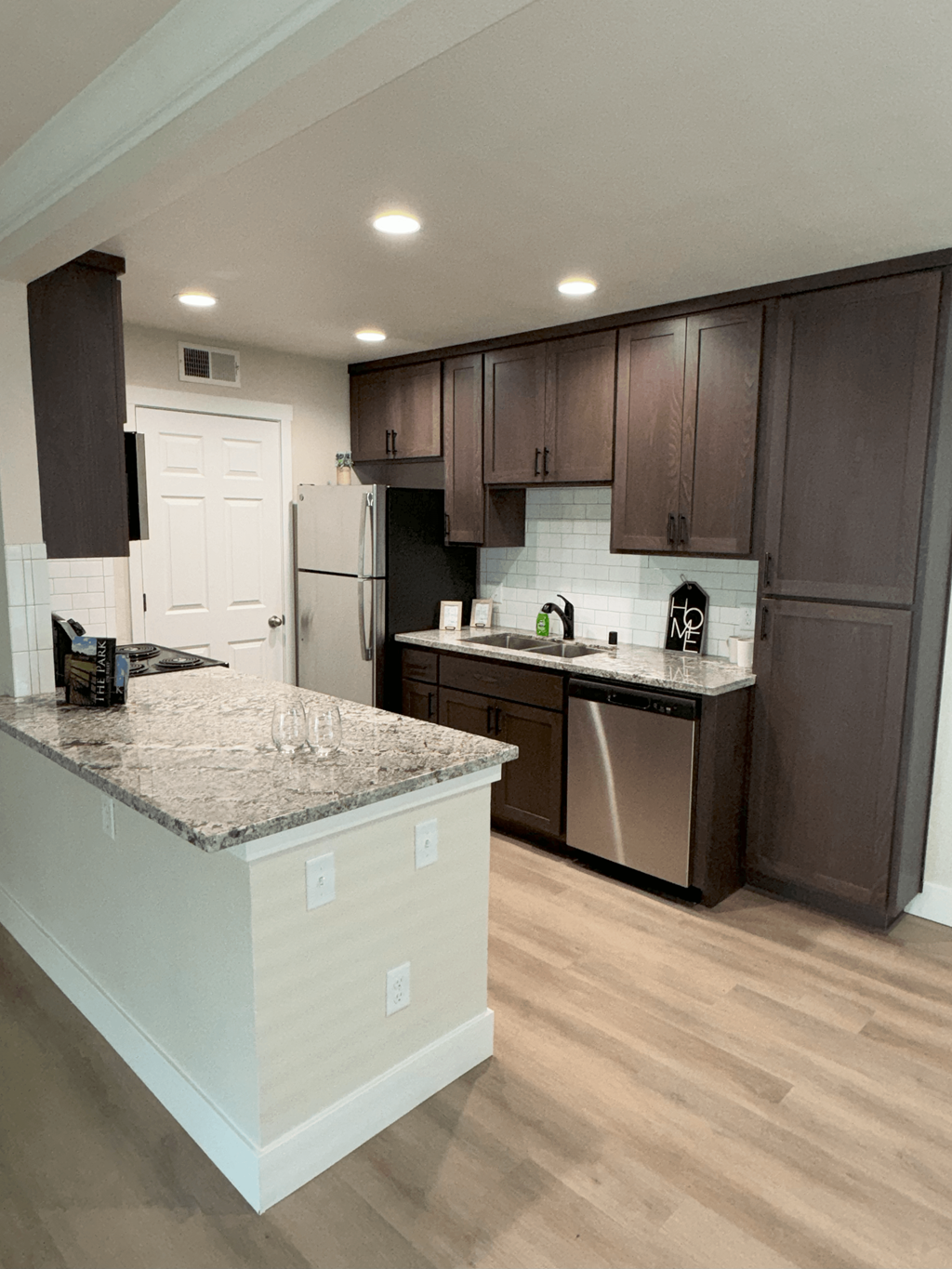 a kitchen with stainless steel appliances and granite counter tops