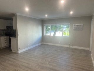 A room with a window and a wall-mounted air conditioner unit.
