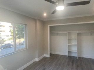 A room with a ceiling fan and a large closet.