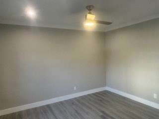 A room with a light on the ceiling and a light switch on the wall.