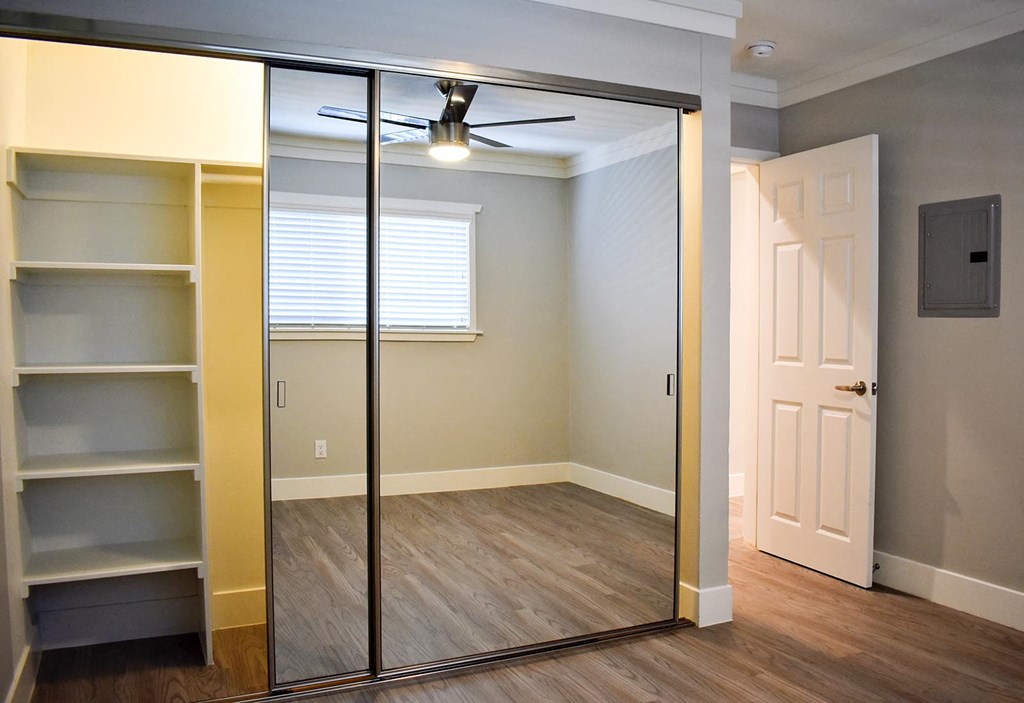 View of bedroom with sliding glass mirror door closet