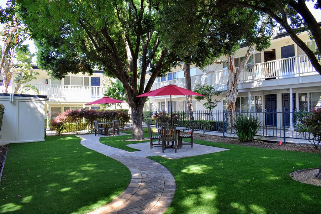 View of fenced courtyard with seating areas