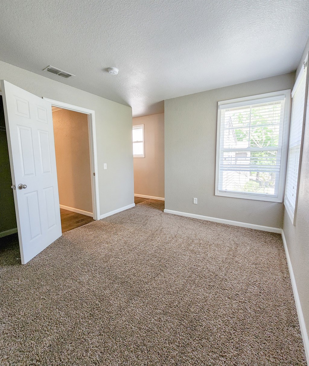 View of bedroom with carpet flooring and well lit windows