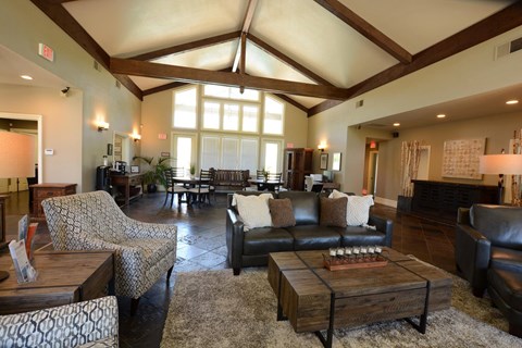 a large living room with leather furniture and large windows