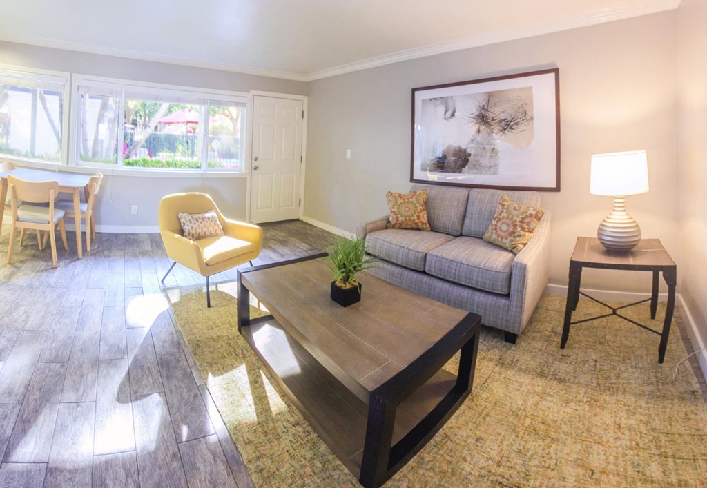 View of living area facing front entry with large well lit windows