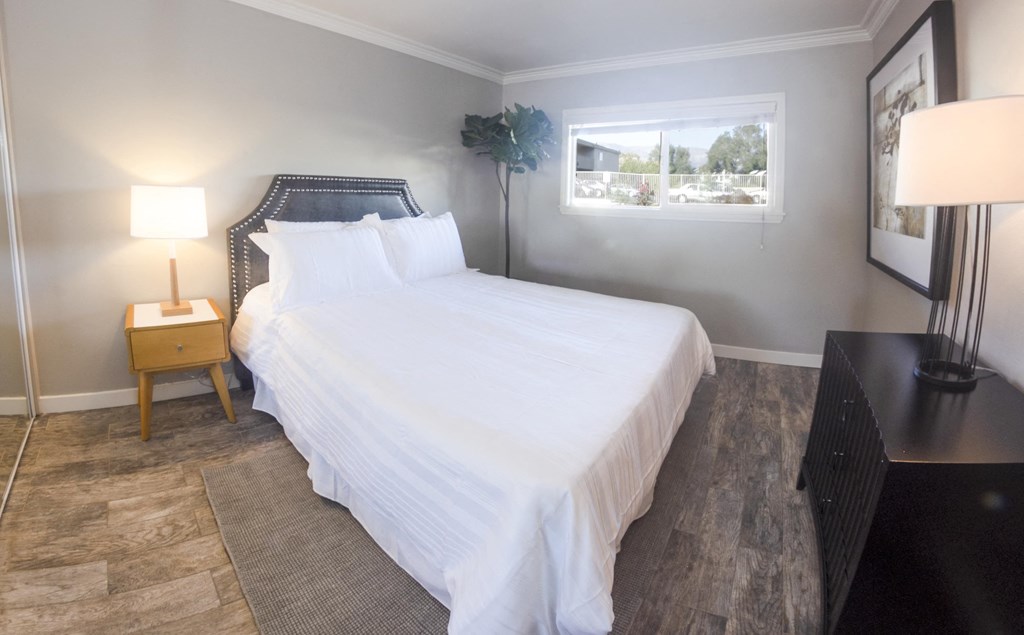 View of furnished model bedroom with large well lit window
