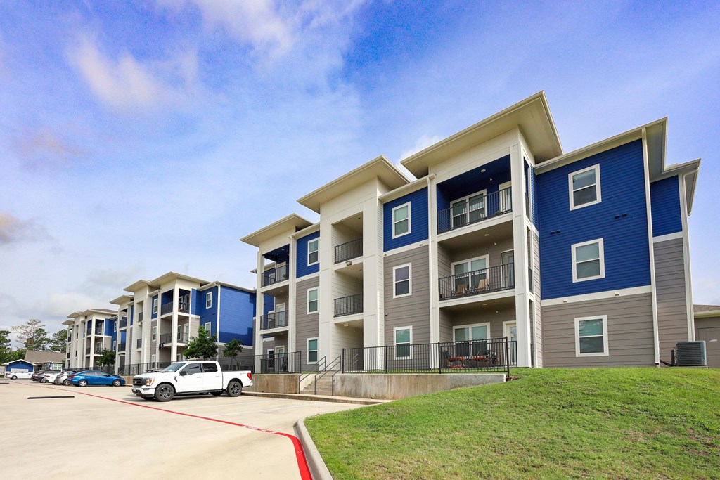 A Blue and White Apartment Building at Midtown Sam Houston Apartments, Huntsville, TX, 77340