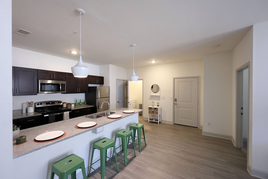 Fitted Kitchen With Island Dining at Midtown Sam Houston Apartments, Huntsville, 77340