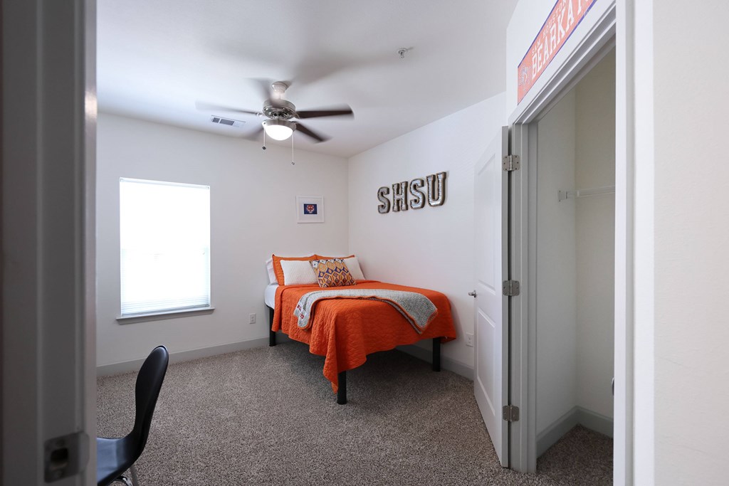 Bedroom with Ceiling Fan at Midtown Sam Houston Apartments, Huntsville, TX, 77340