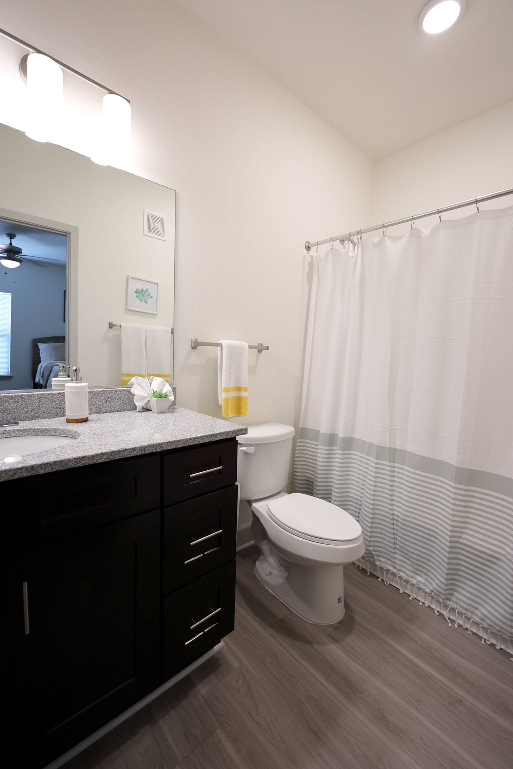 A bathroom with a toilet at Midtown Sam Houston Apartments, Huntsville, Texas