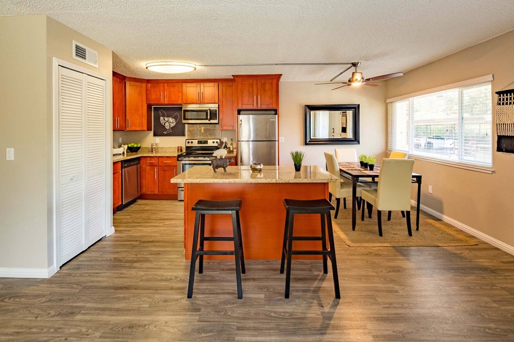 a kitchen and dining room with a table and chairs