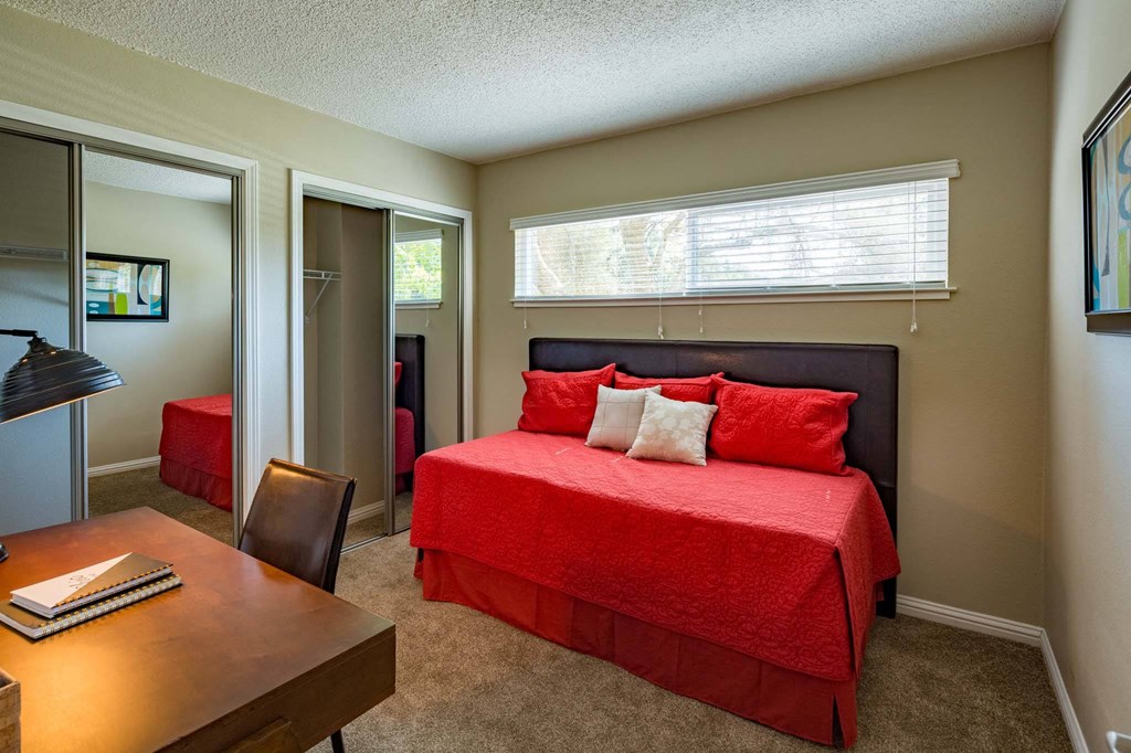 a bedroom with a bed and a desk