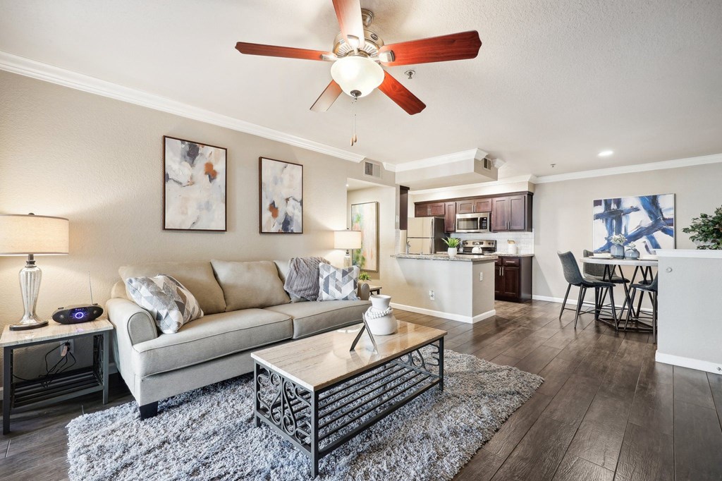 a living room with a couch and a ceiling fan
