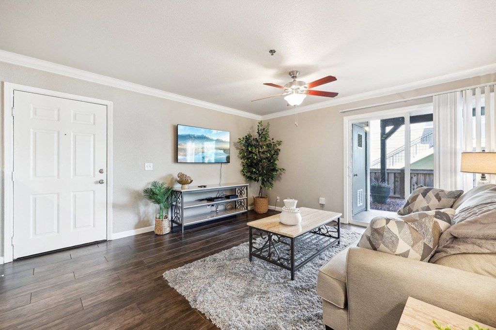 a living room with a couch and a ceiling fan