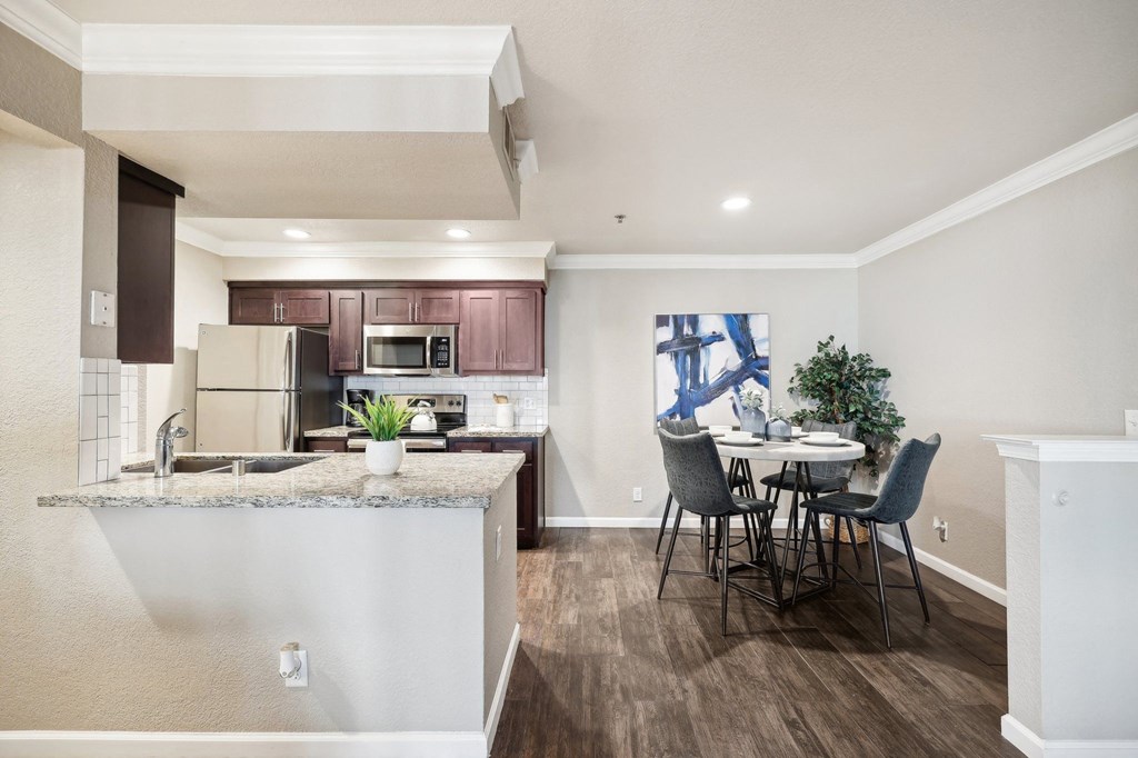 an open kitchen and dining area with a table and chairs
