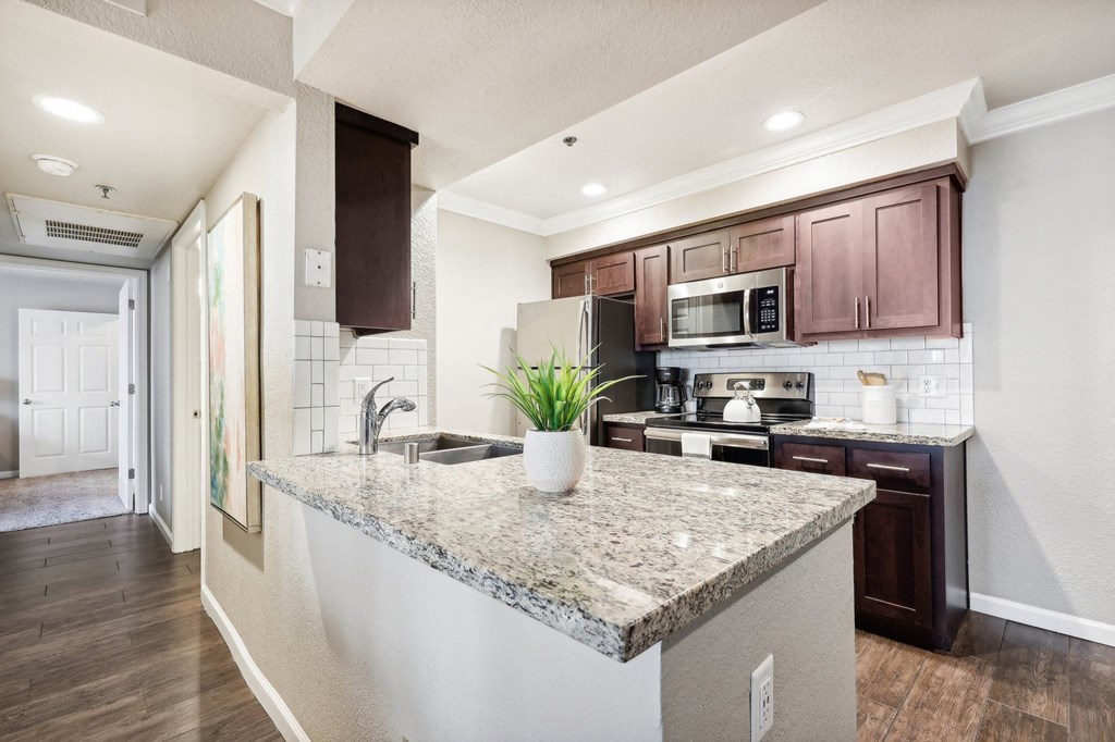 a kitchen with a granite counter top and a sink