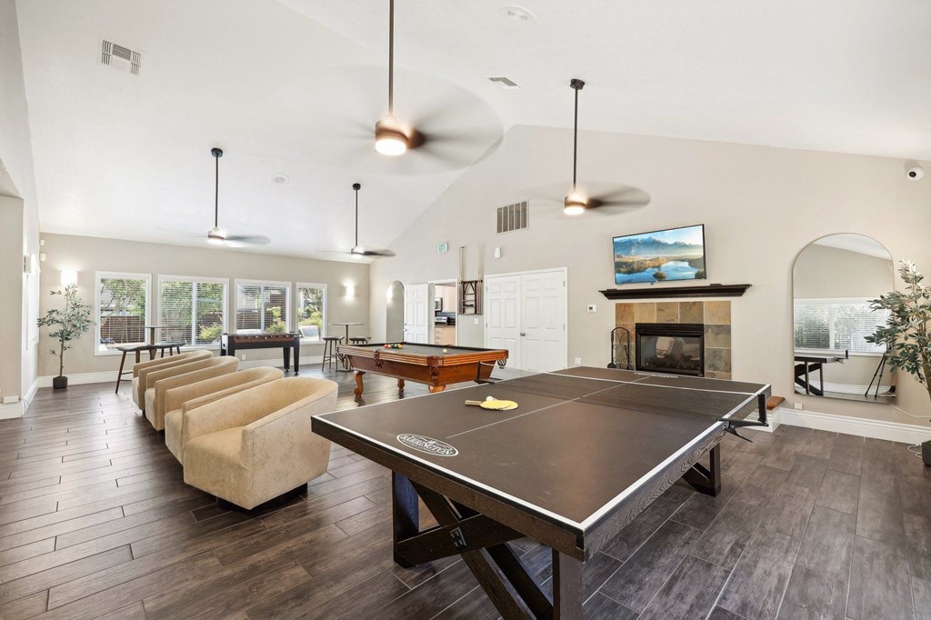 a game room with a pool table and a fireplace