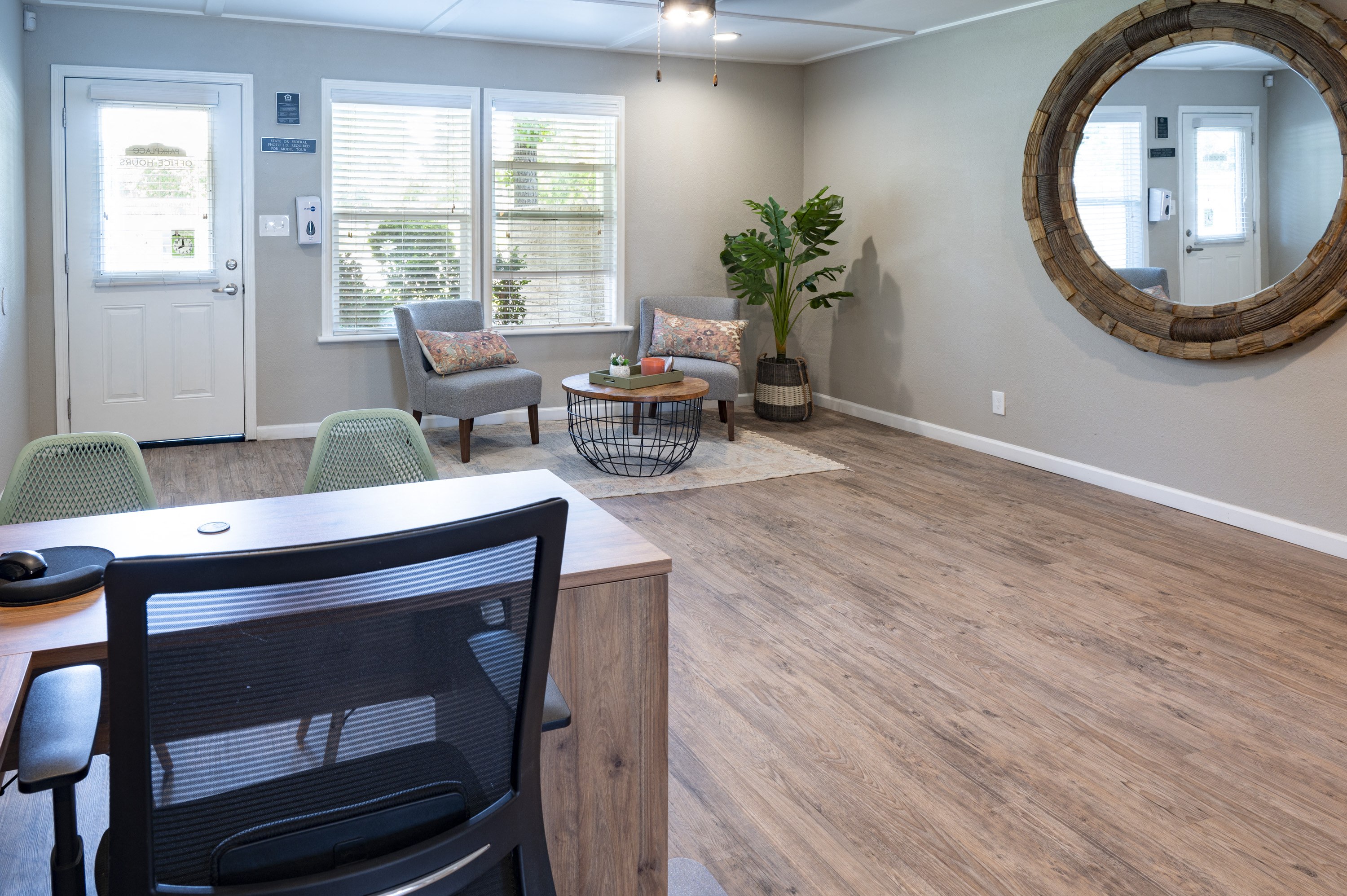 a living room with a table and chairs and a mirror