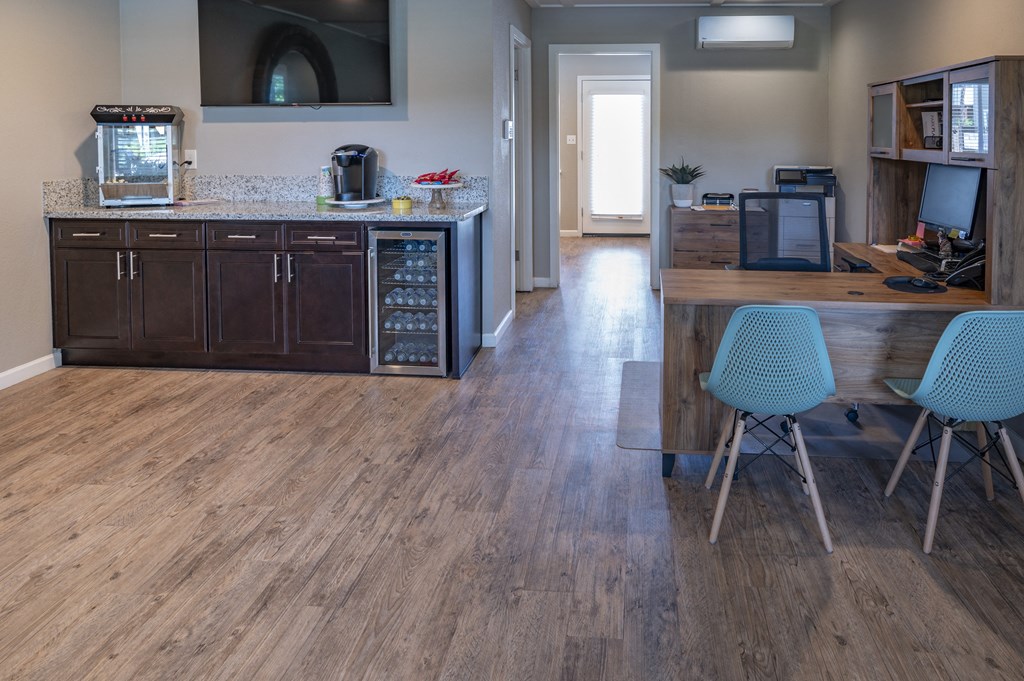 a kitchen and dining room with wood flooring and a table and chairs