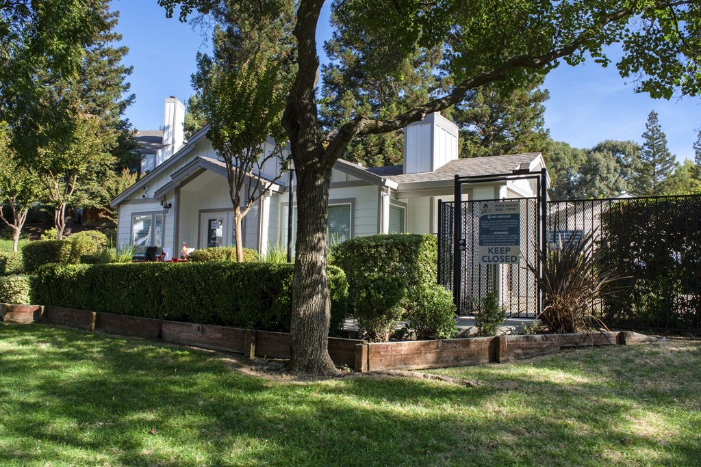 Closer view of the front leasing office, shaded area, next to gated pool