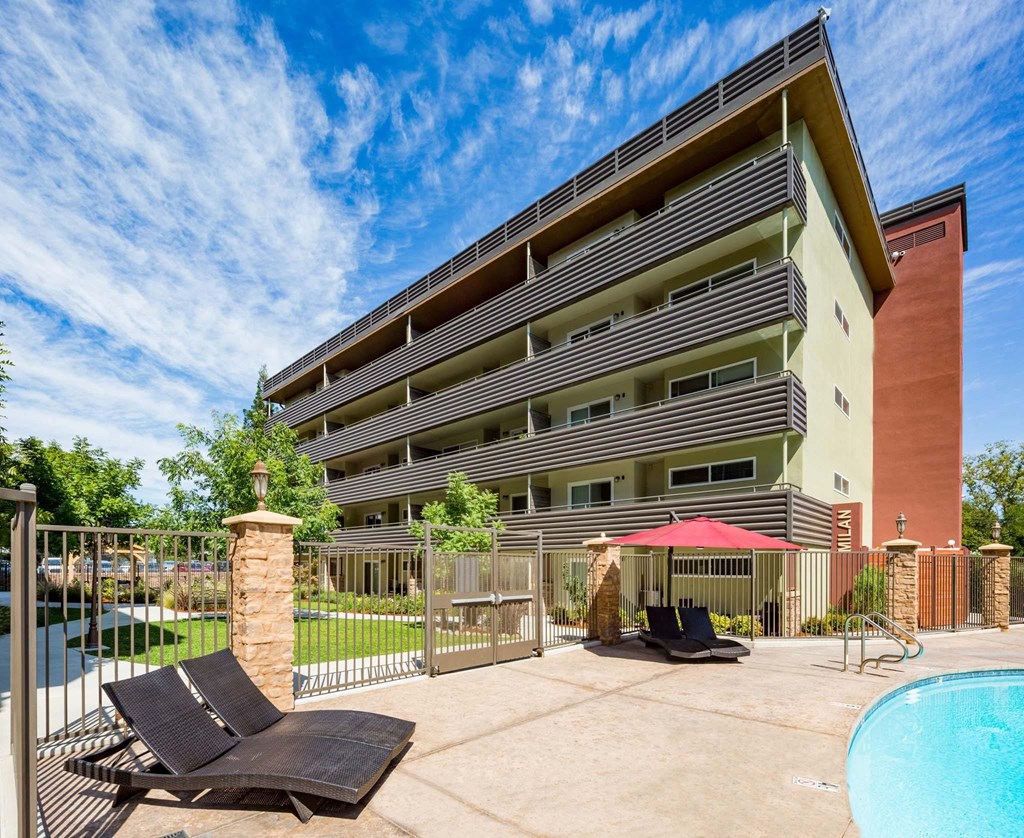 our apartments have a large patio with chairs and a pool