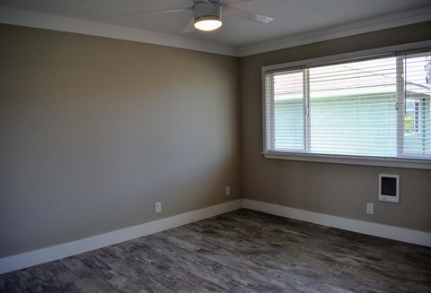 bedroom with neutral walls and large window
