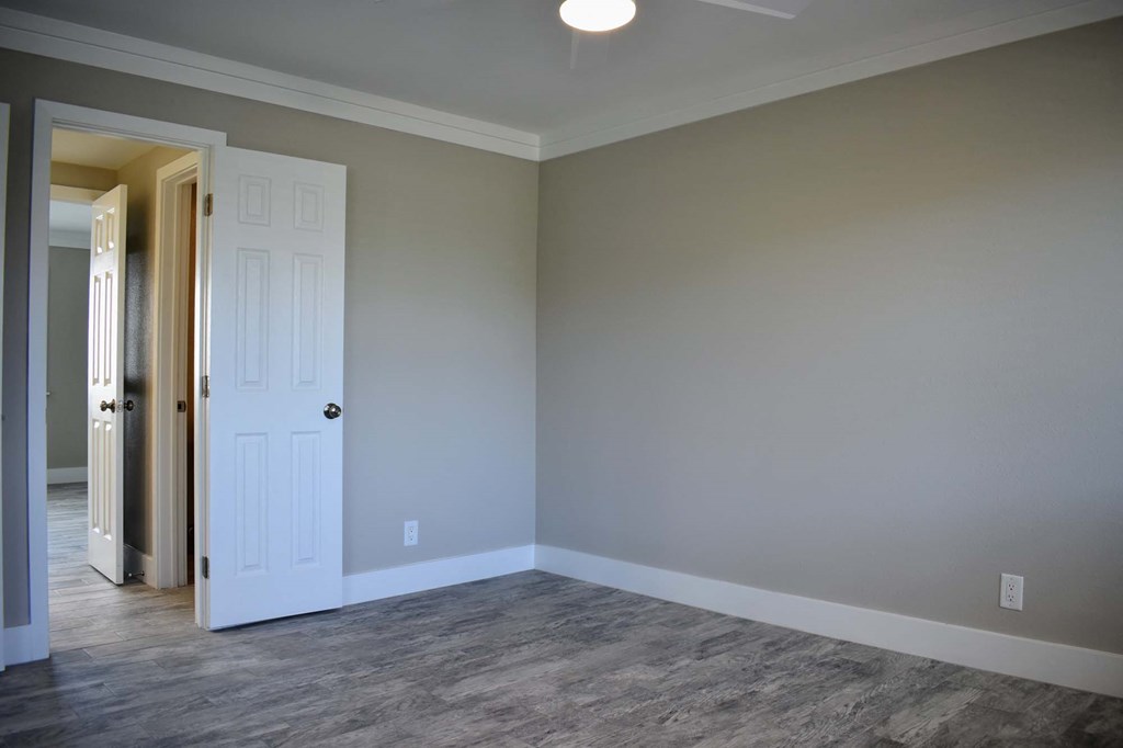 bedroom with wooden floors and neutral walls