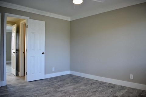bedroom with wooden floors and neutral walls